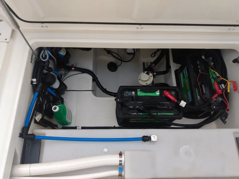Slide: The Image of 2014 Boston Whaler 270 Vantage battery compartment with wiring and components. - 10