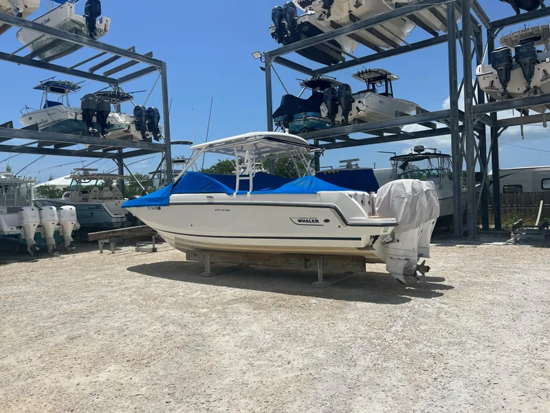 Slide: The Image of Boston Whaler 270 Vantage 2014 boat stored outdoors with protective cover. - 12