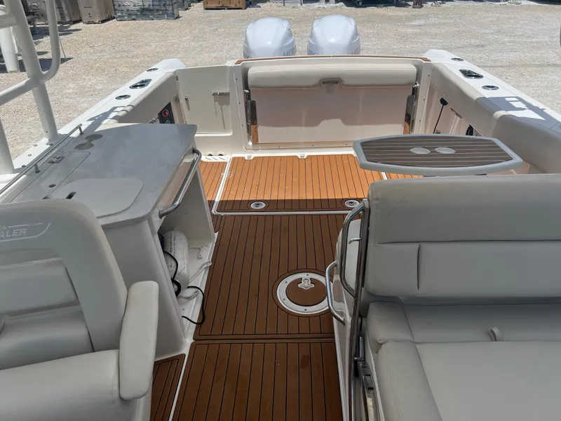 Slide: The Image of 2014 Boston Whaler 270 Vantage interior with teak flooring and seating. - 2