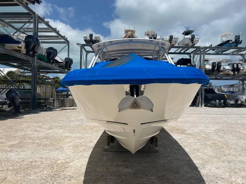 Slide: The Image of 2014 Boston Whaler 270 Vantage boat with blue cover, stored outdoors. - 6