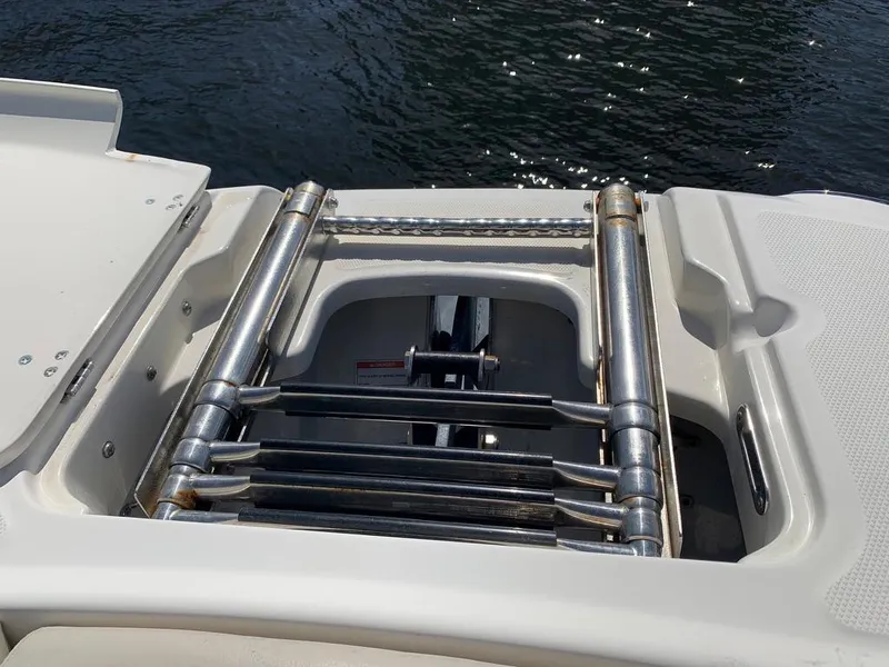 Slide: The Image of Foldable ladder on a 2014 Boston Whaler 270 Vantage boat, near water. - 8