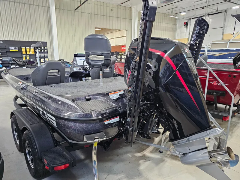Slide: The Image of 2024 Nitro Z19 Pro bass boat with powerful outboard motor in showroom. - 2