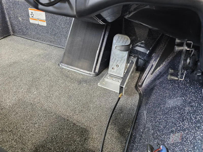 Slide: The Image of 2024 Nitro Z19 Pro boat foot pedal and carpeted interior detail. - 5