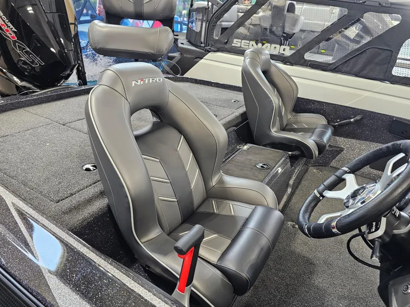 Slide: The Image of 2024 Nitro Z19 Pro boat interior with sleek black seats and modern steering wheel. - 6