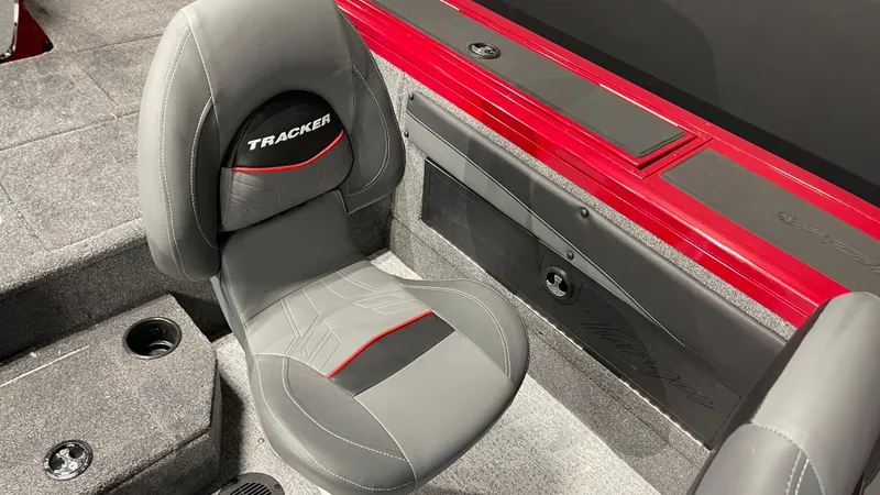 Slide: The Image of 2024 Tracker Targa V-19 Combo boat interior with gray seat and red accents. - 14