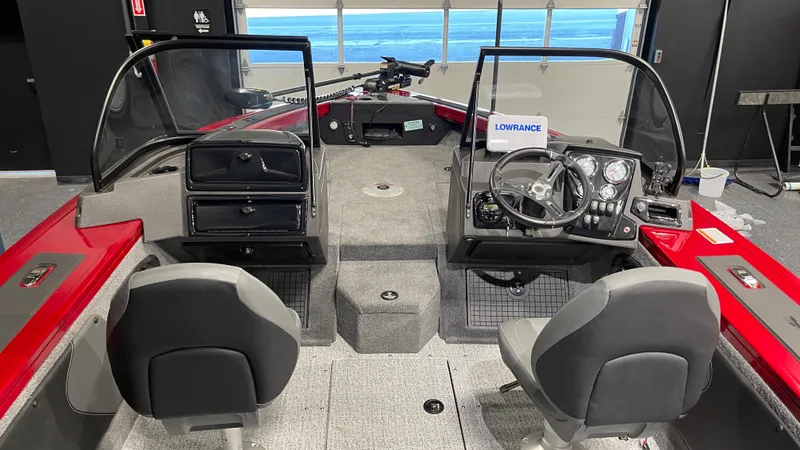 Slide: The Image of 2024 Tracker Targa V-19 Combo boat interior with dual seats and steering console. - 7