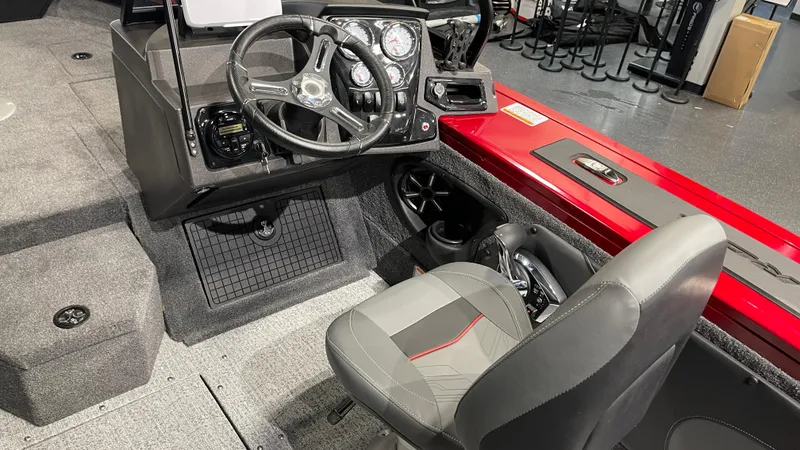 Slide: The Image of 2024 Tracker Targa V-19 Combo boat interior with steering wheel and seating. - 9
