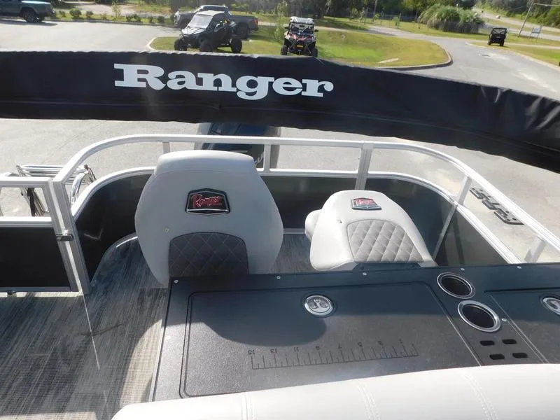 Slide: The Image of 2024 Ranger Reata 223FC boat interior with seating and console. - 3
