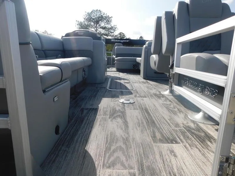 Slide: The Image of 2024 Ranger Reata 223FC pontoon boat interior with spacious seating and modern flooring. - 5