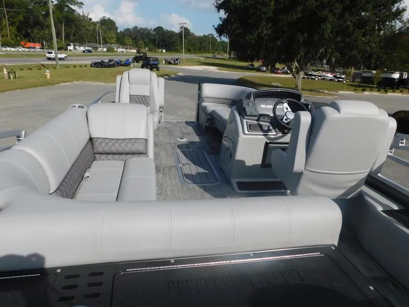 Slide: The Image of 2024 Ranger Reata 223FC boat interior with gray seating and steering console. - 7
