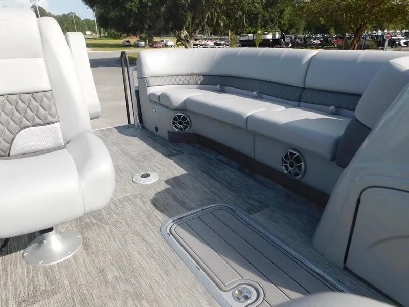 Slide: The Image of 2024 Ranger Reata 223FC boat interior with gray seating and flooring. - 8