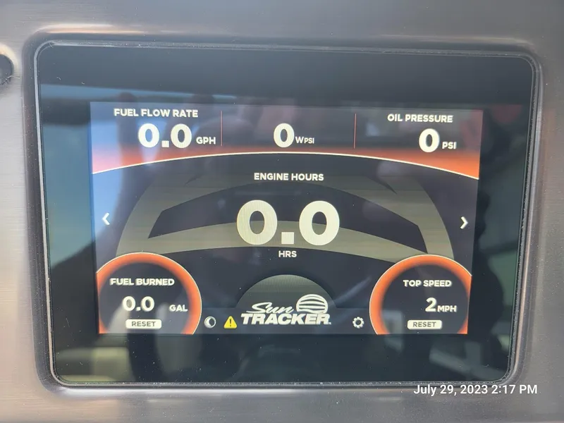 Slide: The Image of Sun Tracker SportFish 22 XP3 2024 dashboard display showing fuel flow, oil pressure, engine hours, and top speed. - 8