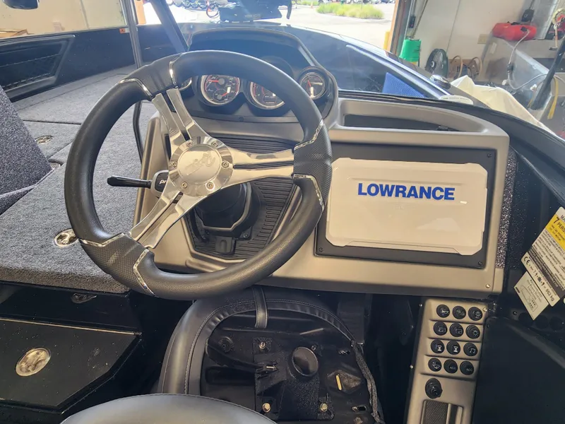 Slide: The Image of 2024 Ranger 1880MS boat dashboard with Lowrance navigation system and steering wheel. - 5