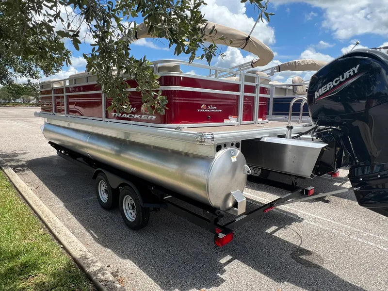 Slide: The Image of 2024 Sun Tracker Party Barge 22 RF DLX pontoon boat on trailer. - 3