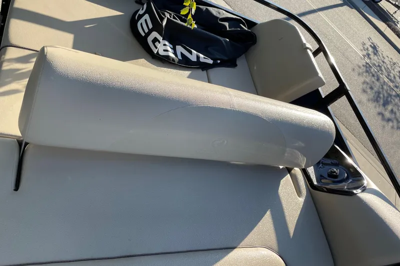 Slide: The Image of 2024 Regency 250 DL3 boat interior with beige seating and storage compartment. - 5