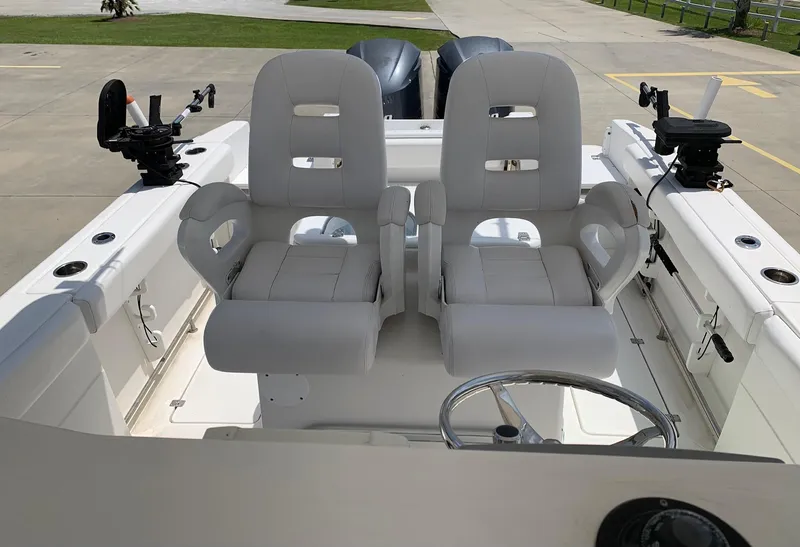 Slide: The Image of 2013 Sea Fox 286 CC boat with dual captain's chairs and fishing rod holders. - 15
