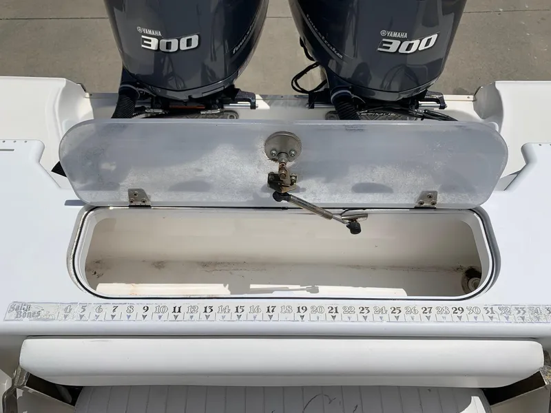 Slide: The Image of 2013 Sea Fox 286 CC boat with Yamaha 300 engines and open storage compartment. - 10