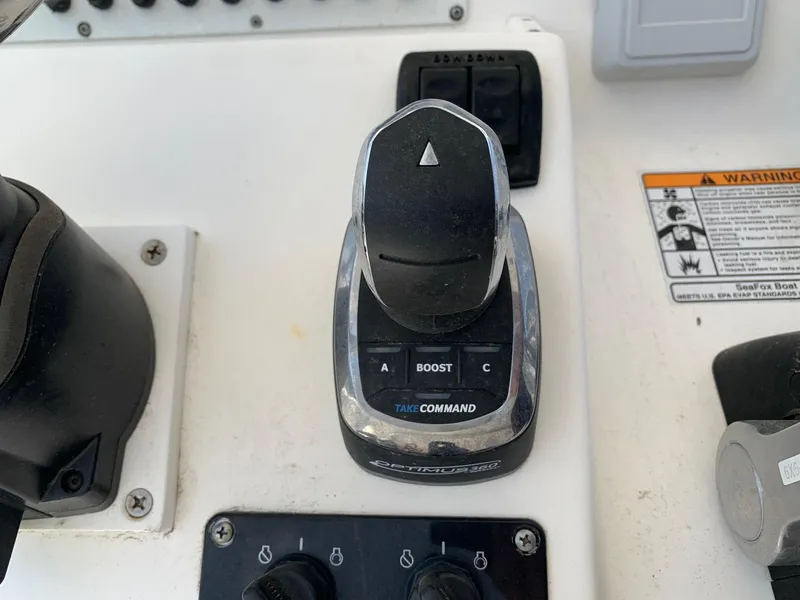 Slide: The Image of 2013 Sea Fox 286 CC boat control panel with throttle and boost button. - 8