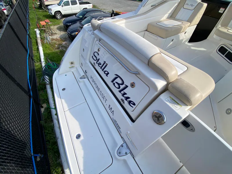 Slide: The Image of 2013 Sea Ray 310 Sundancer boat named "Stella Blue" docked, rear view. - 6