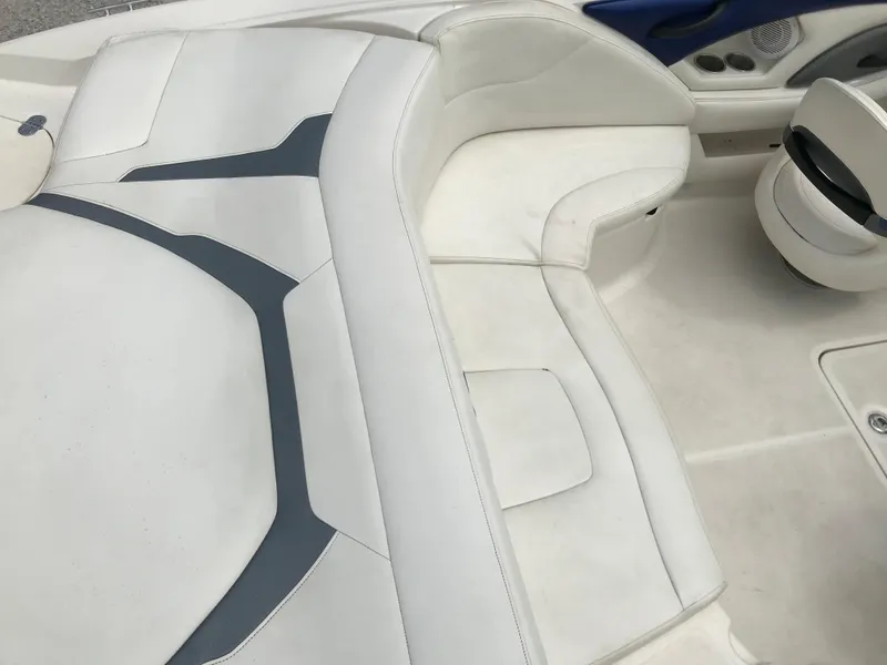 Slide: The Image of 2010 Monterey 214FS boat interior with white and gray seating. - 10