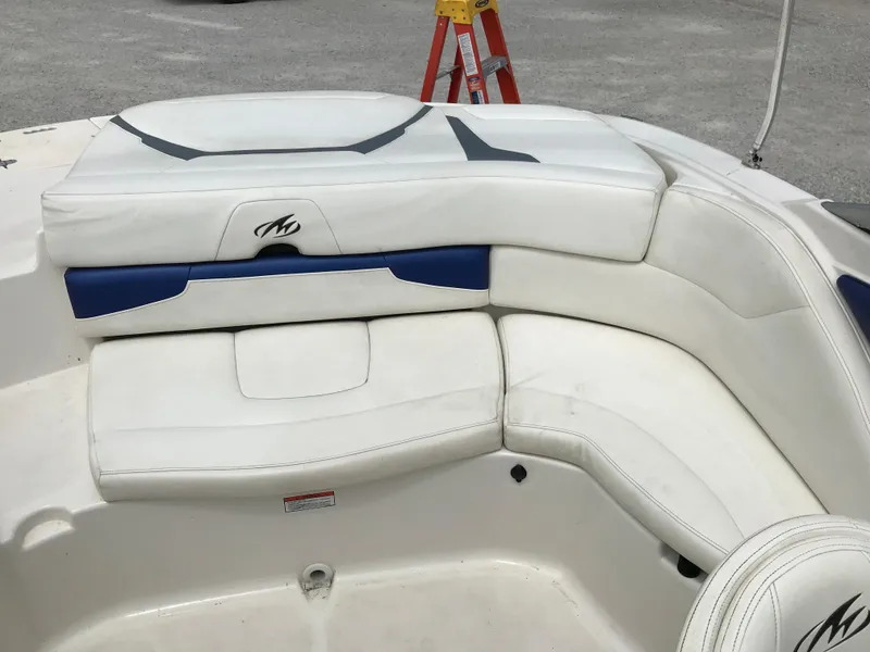 Slide: The Image of 2010 Monterey 214FS boat with white and blue cushioned seating. - 11
