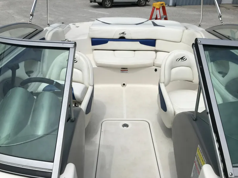 Slide: The Image of 2010 Monterey 214FS boat interior with white and blue seating. - 14