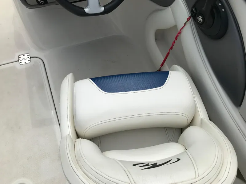 Slide: The Image of 2010 Monterey 214FS boat interior with white and blue seating. - 20