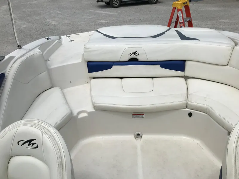 Slide: The Image of 2010 Monterey 214FS boat interior with white and blue seating. - 24