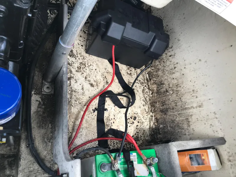 Slide: The Image of Battery compartment of a 2010 Monterey 214FS boat with wiring and components. - 27