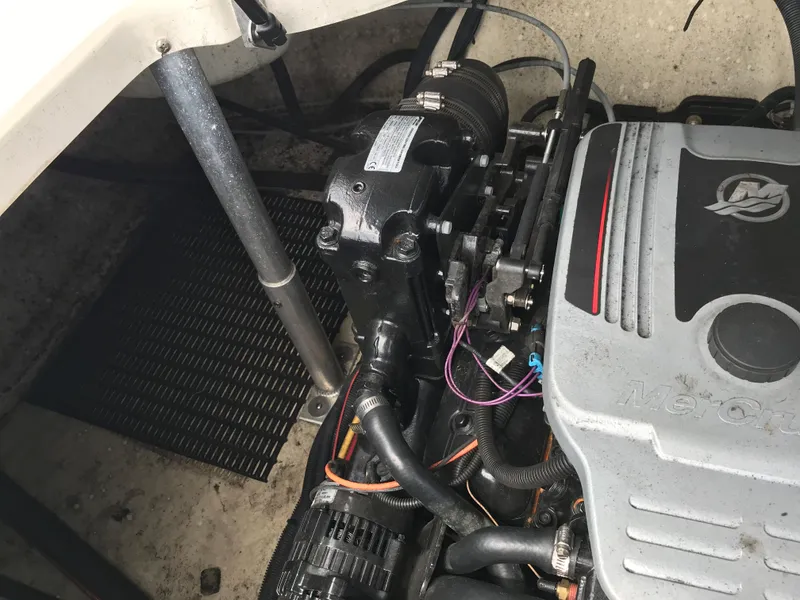 Slide: The Image of 2010 Monterey 214FS boat engine compartment with visible engine components. - 28