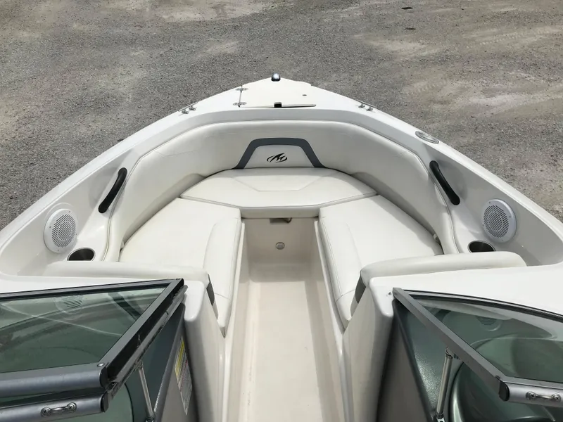 Slide: The Image of 2010 Monterey 214FS boat interior with white seating and open bow. - 29