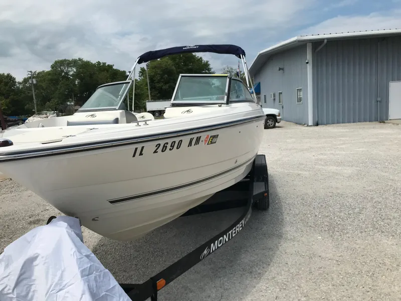 Slide: The Image of 2010 Monterey 214FS boat on trailer in outdoor storage area. - 7