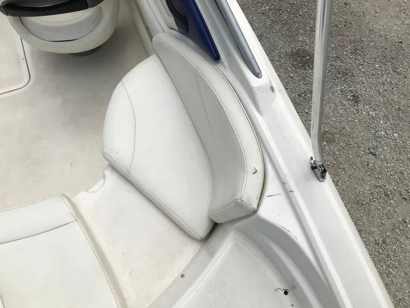Slide: The Image of 2010 Monterey 214FS boat interior with white seating and flooring. - 9