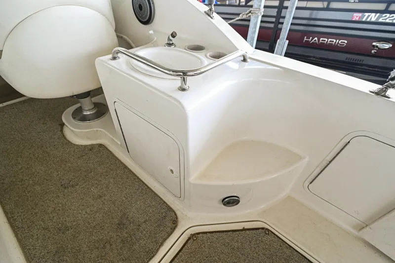 Slide: The Image of 2001 Sea Ray 260 Sundancer boat interior with seating and storage compartments. - 12