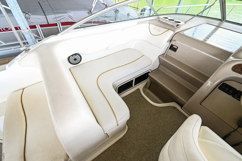 Slide: The Image of 2001 Sea Ray 260 Sundancer cockpit seating area with white upholstery. - 14