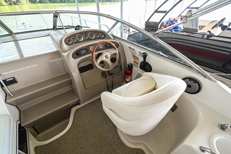 Slide: The Image of 2001 Sea Ray 260 Sundancer boat helm with steering wheel and control panel. - 15