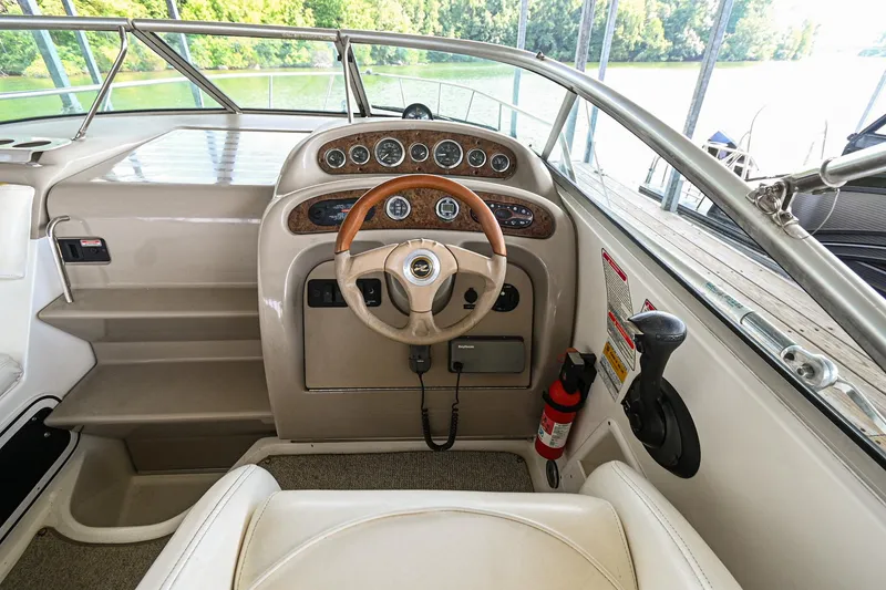 Slide: The Image of 2001 Sea Ray 260 Sundancer helm with steering wheel and instrument panel. - 16
