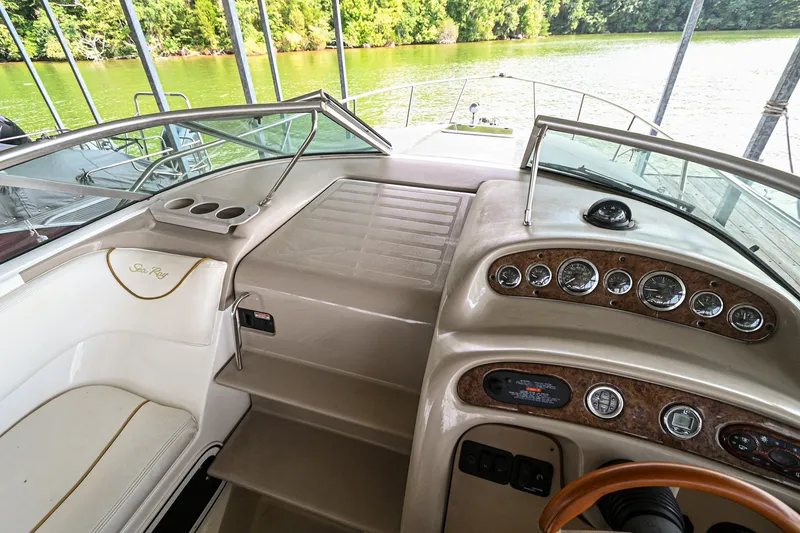 Slide: The Image of 2001 Sea Ray 260 Sundancer boat interior with dashboard and seating. - 17