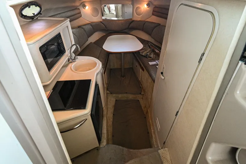 Slide: The Image of 2001 Sea Ray 260 Sundancer cabin interior with kitchenette and seating area. - 22