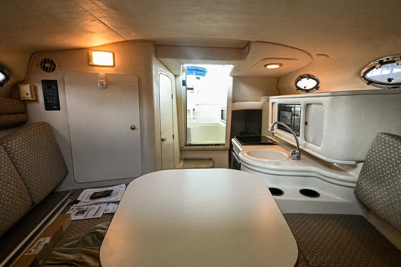 Slide: The Image of Interior cabin of a 2001 Sea Ray 260 Sundancer boat with kitchenette and seating area. - 23