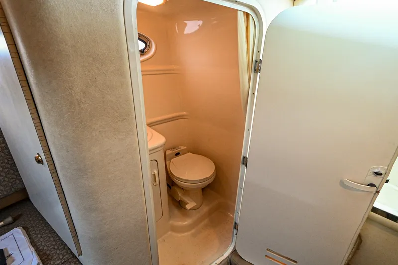 Slide: The Image of 2001 Sea Ray 260 Sundancer boat bathroom with toilet and sink. - 32