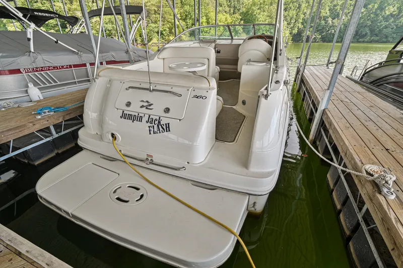 Slide: The Image of 2001 Sea Ray 260 Sundancer docked, rear view with Jumpin' Jack Flash name. - 4
