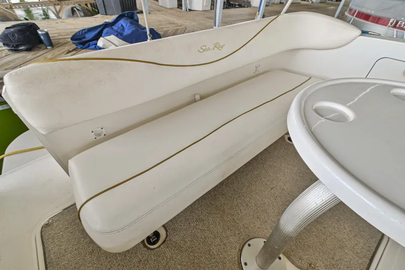 Slide: The Image of 2001 Sea Ray 260 Sundancer boat interior with white seating and table. - 6