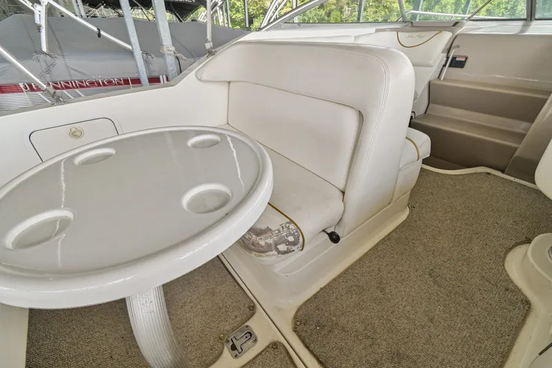 Slide: The Image of Interior seating and table of a 2001 Sea Ray 260 Sundancer boat. - 7