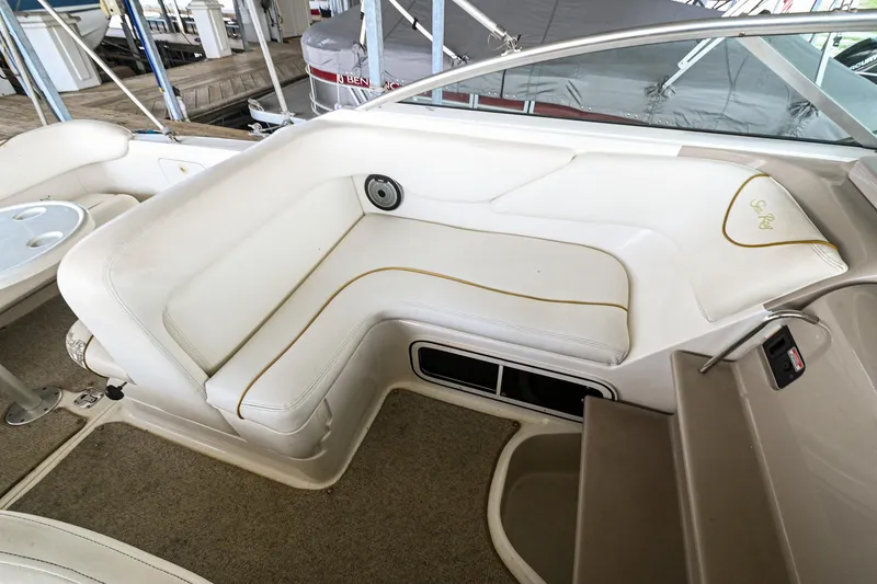Slide: The Image of 2001 Sea Ray 260 Sundancer interior seating area with white upholstery. - 8