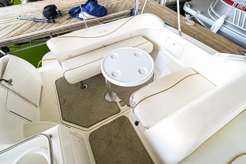 Slide: The Image of 2001 Sea Ray 260 Sundancer boat interior with seating and table. - 9