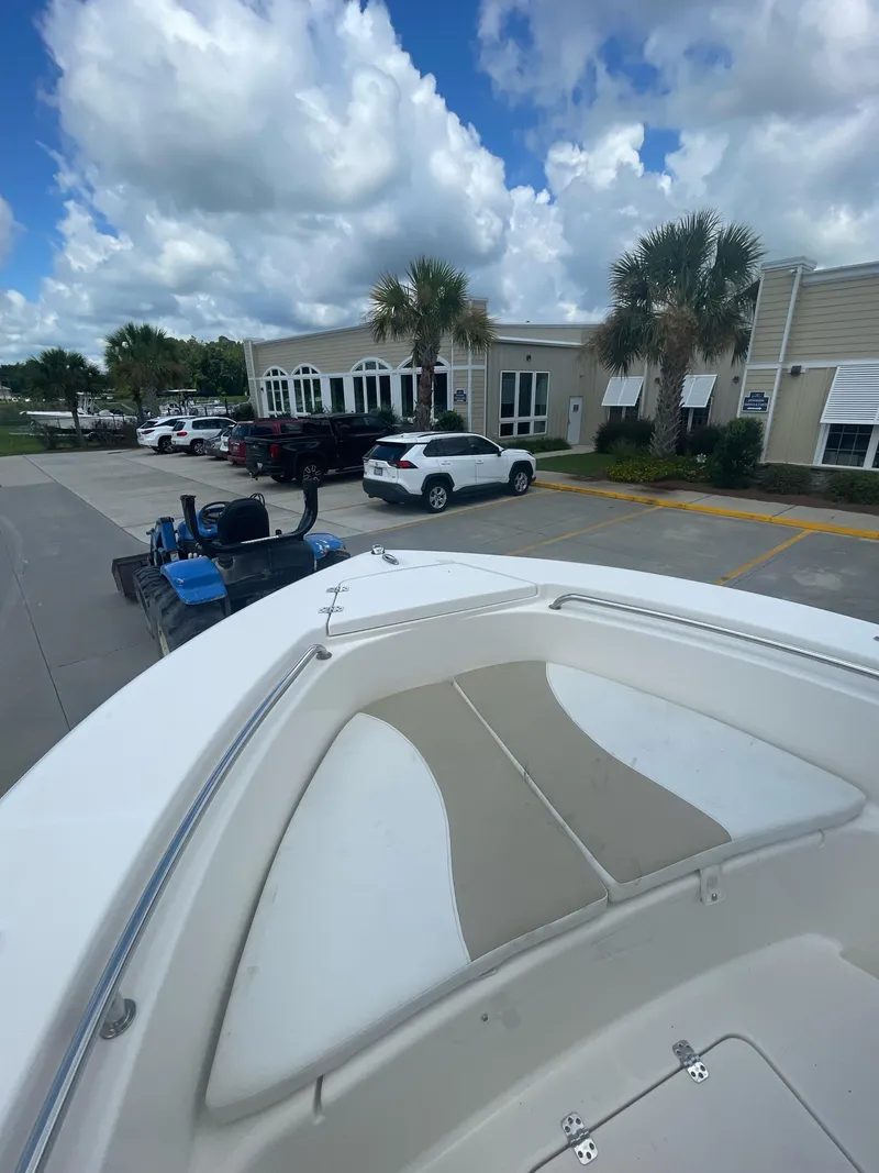 Slide: The Image of 2021 Bulls Bay 200 CC boat parked near a building under a cloudy sky. - 21