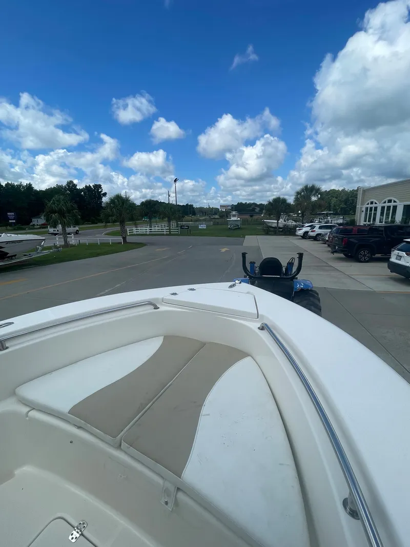 Slide: The Image of Bulls Bay 200 CC 2021 boat on trailer in parking lot under blue sky. - 22