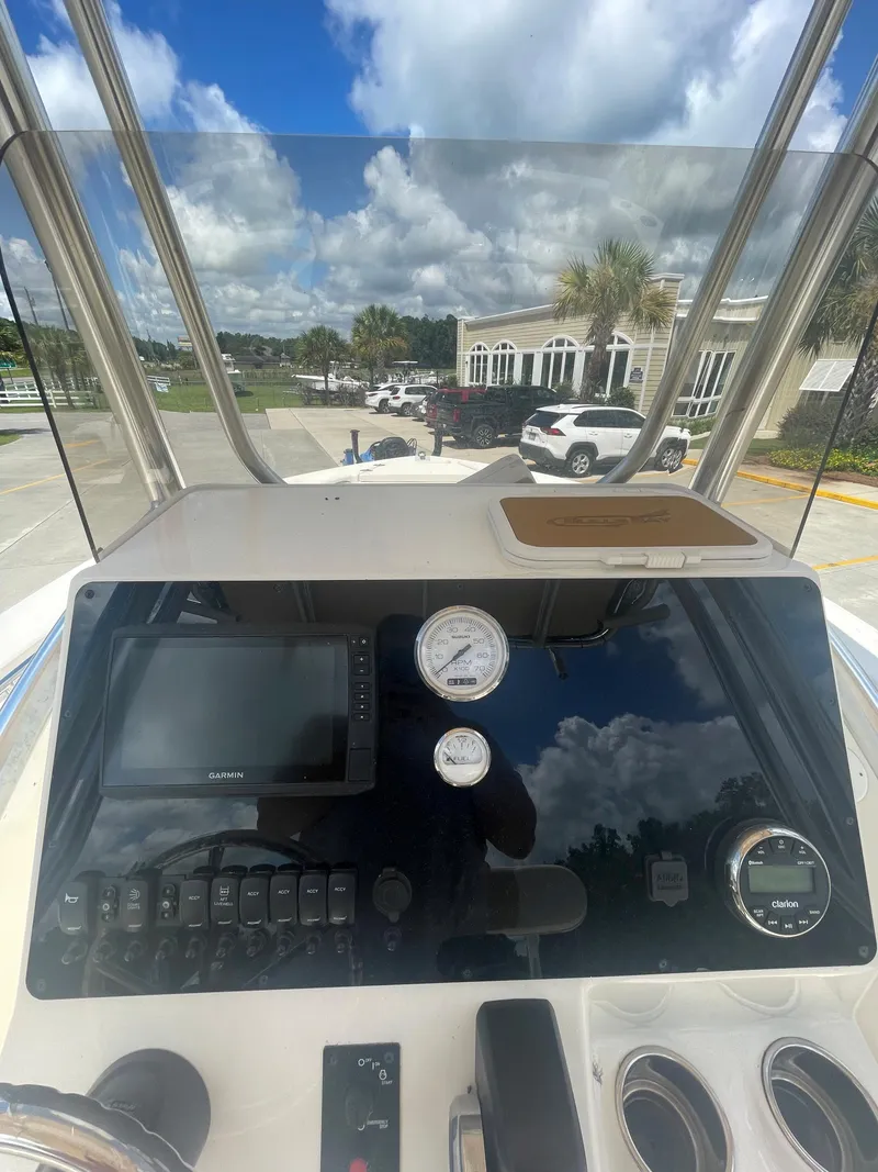 Slide: The Image of 2021 Bulls Bay 200 CC boat dashboard with navigation system and gauges. - 12