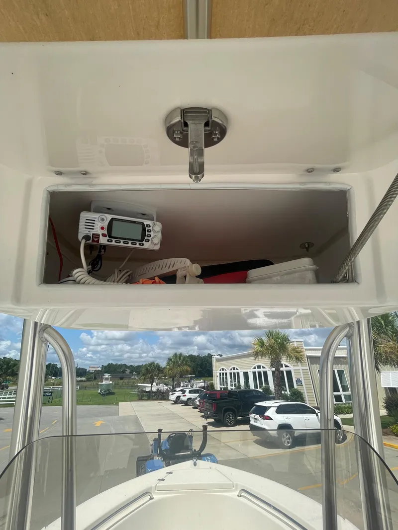 Slide: The Image of Bulls Bay 200 CC 2021 boat console storage with marine radio and equipment. - 13
